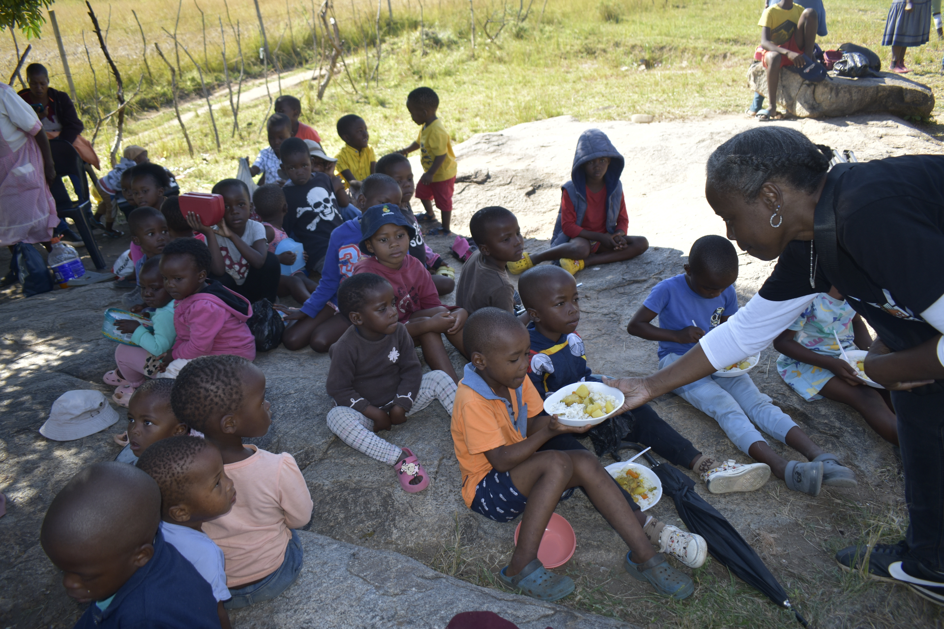 Seven Pillars team distributing meals to children in Eswatini