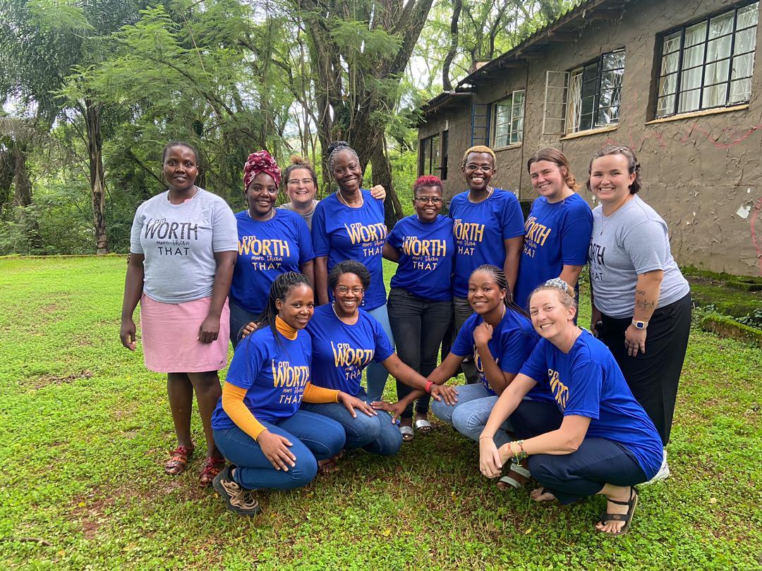 3W team gathered outdoors in I Am Worth More Than That shirts